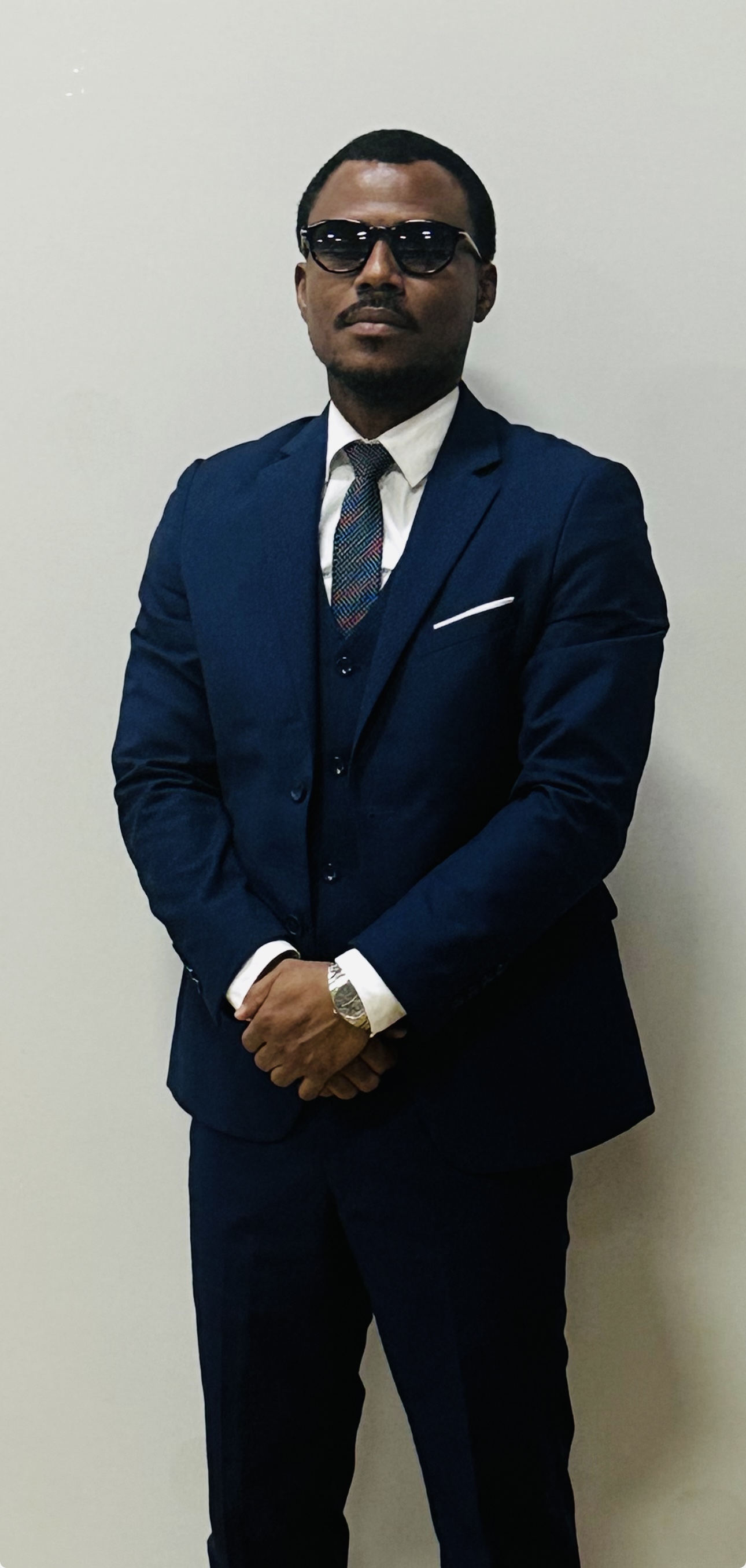 Junior Ceranor Nelson in a navy three-piece suit